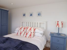 A bedroom with a bed and bedside table at Stella Maris in Torpoint