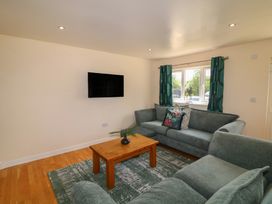 A living room with a television and window at James Ville Marina Lodge 22 in Brigg