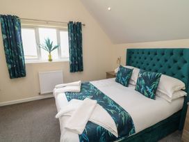 A bedroom with a bed and curtains at James Ville Marina Lodge 22 in Brigg