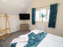 A bedroom with a bed and a television at James Ville Marina Lodge 22 in Brigg