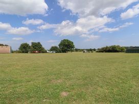 An outdoor area with an airplane, a hangar, and a shed at 1 Bed Sleeps 4, Shared Bathroom in Monewden near Otley, Suffolk