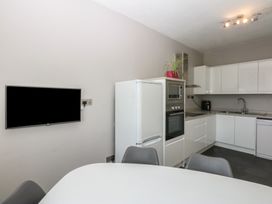 A kitchen with a refrigerator and oven at Cwtch y Môr Trearddur Bay