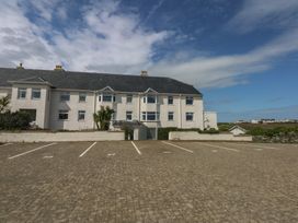 A house with a parking lot and plants at Cwtch y Môr in Trearddur Bay