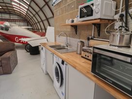 A kitchen with appliances and a plane in the background at Oak Tree in Monewden near Otley Suffolk