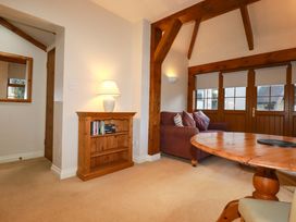 A living room with a sofa and a bookshelf at Farrier Cottage in Falmouth