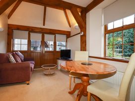 A living room with a sofa and table at Farrier Cottage in Falmouth