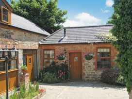 Exterior of a cottage with brick walls and plants at Farrier Cottage Budock Water near Falmouth
