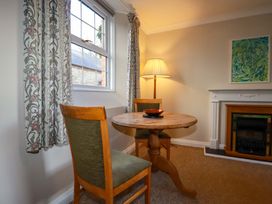 A dining room with a table and chairs at Horseshoe Cottage in Falmouth