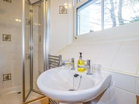 A bathroom with a sink and shower at Horseshoe Cottage in Falmouth