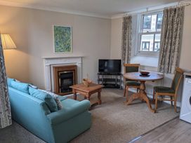 A living room with a sofa and coffee table at Horseshoe Cottage Budock Water near Falmouth