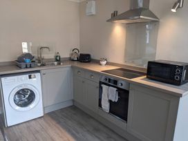 A kitchen with appliances and fixtures at Horseshoe Cottage Budock Water near Falmouth