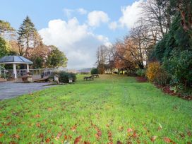 A garden with green grass and trees at The Hayloft in Falmouth