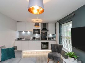 A kitchen with a sofa and appliances at Rosie's Retreat in Filey