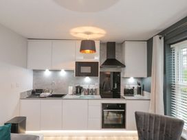 A kitchen with appliances and cabinets at Rosie's Retreat in Filey