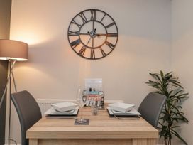 A dining room with a table set for meals at Rosie's Retreat in Filey