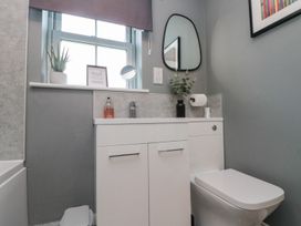 A bathroom with a sink and toilet at Rosie's Retreat in Filey
