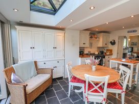 A kitchen with dining table and chairs at Woodbine Cottage in Whitby