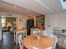 A kitchen with a round table and chairs at Woodbine Cottage in Whitby