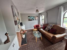 A living room with a sofa and coffee table at Lilly's Bungalow in Timoleague