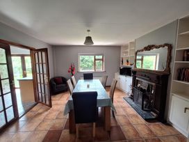 A dining room with a table and chairs at Lilly's Bungalow in Timoleague