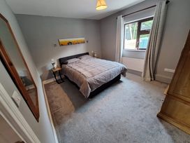 A bedroom with a bed and a window at Lilly's Bungalow in Timoleague