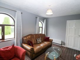 A living room with a sofa and armchair at Lilly's Bungalow in Clonakilty, County Cork