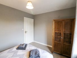 A bedroom with a bed and wardrobe at Lilly's Bungalow, Clonakilty, County Cork