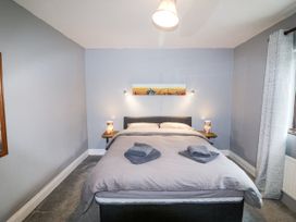 A bedroom with a bed and bedside table at Lilly's Bungalow in Clonakilty, County Cork