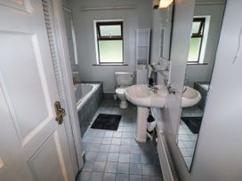A bathroom with a bathtub, sink, and toilet at Lilly's Bungalow, Clonakilty, County Cork