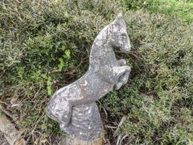 A horse statue next to greenery at Lilly's Bungalow, Clonakilty, County Cork