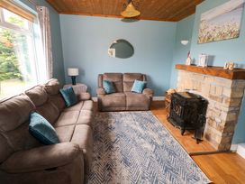 A living room with sofas and a fireplace at CARROWREAGH