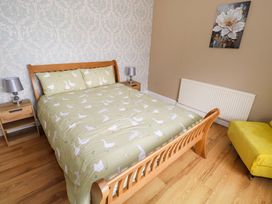 A bedroom with a bed and a chair at CARROWREAGH