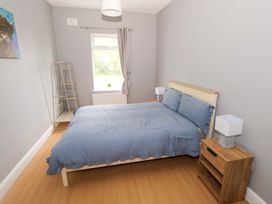 A bedroom with a bed and a bedside table at CARROWREAGH