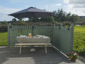 An outdoor seating area with a table and umbrella at Carrowreagh, Aclare, County Sligo