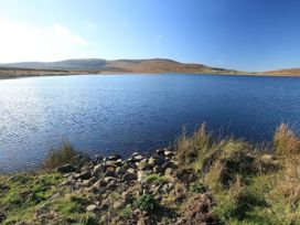 A lake surrounded by grass and rocks at Carrowreagh in Aclare, County Sligo