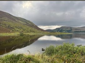 A lake with mountains and grass in the foreground at Carrowreagh in Aclare, County Sligo