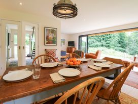 A dining room with a table set for meals at Lakeside Lodge Witherenden Hill near Burwash