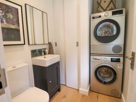 A laundry room with a washer and dryer at Lakeside Lodge Witherenden Hill near Burwash