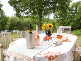 A table set with wine and food at Lakeside Lodge in Witherenden Hill near Burwash