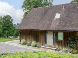 An exterior view of a wooden building with a door and windows at Lakeside Lodge in Witherenden Hill near Burwash