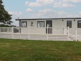 A mobile home with a deck and railing at The Maples, no. 56 Hewas Water near Polgooth