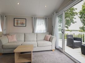 A living room with a sofa and coffee table at The Maples, no. 56 Hewas Water near Polgooth