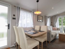 A dining room with a table and chairs at The Maples, no. 56 Hewas Water near Polgooth