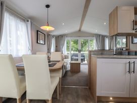 A living room with a dining table and sofa at The Maples, no. 56 Hewas Water near Polgooth