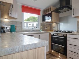 A kitchen with a sink and cooktop at The Maples, no. 56 Hewas Water near Polgooth