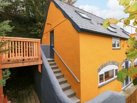 A house with a deck and stairs at Pendre Barn Star near Cenarth