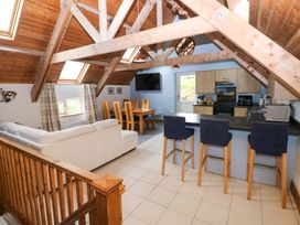 A living room with a kitchen and dining area at Pendre Barn Star near Cenarth