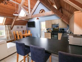 A kitchen with a dining table and chairs at Pendre Barn Star near Cenarth