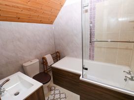 A bathroom with a sink, toilet and bathtub at Pendre Barn Star near Cenarth
