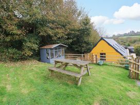 A picnic table and shed in a garden at Pendre Barn Star near Cenarth